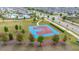 Community outdoor basketball court surrounded by landscaping and green space for friendly neighborhood competition at 10684 Words Dr, Winter Garden, FL 34787
