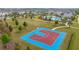 Aerial shot of a community outdoor basketball court surrounded by landscaping and green space for recreation at 10684 Words Dr, Winter Garden, FL 34787