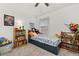 Bedroom featuring neutral carpet, a ceiling fan, and a bed with under-bed storage drawers at 10684 Words Dr, Winter Garden, FL 34787