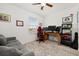 Comfortable bedroom with a ceiling fan, desk, sofa and a view from the window at 10684 Words Dr, Winter Garden, FL 34787