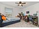 Bedroom featuring neutral carpet, a ceiling fan, and a bed with under-bed storage drawers at 10684 Words Dr, Winter Garden, FL 34787