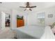 Bright bedroom featuring neutral carpet, a ceiling fan, and a wooden dresser with a TV at 10684 Words Dr, Winter Garden, FL 34787