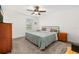 Well-lit bedroom featuring neutral carpet, a ceiling fan, and a metal bed frame at 10684 Words Dr, Winter Garden, FL 34787