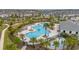 Scenic view of the expansive community pool area, complete with a splash pad and palm trees at 10684 Words Dr, Winter Garden, FL 34787
