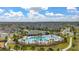 Gorgeous view of a community pool surrounded by palm trees, seating and sidewalks to nearby homes at 10684 Words Dr, Winter Garden, FL 34787