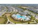 Beautiful aerial shot of a community pool surrounded by palm trees, green space, and townhomes at 10684 Words Dr, Winter Garden, FL 34787