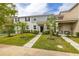 Charming two-story townhome featuring a manicured lawn, gray accents and a welcoming front entrance at 10684 Words Dr, Winter Garden, FL 34787