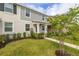 Attractive two-story townhome showcases manicured landscaping and a walkway leading to a covered front porch at 10684 Words Dr, Winter Garden, FL 34787