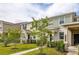 Attractive townhome exterior with a tidy lawn and inviting walkway to the entrance at 10684 Words Dr, Winter Garden, FL 34787