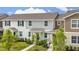 Exterior showcasing a neat lawn and neutral-tone facade with stylish architectural detail at 10684 Words Dr, Winter Garden, FL 34787