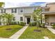 Charming townhome featuring a well-manicured lawn and inviting walkway to the front door at 10684 Words Dr, Winter Garden, FL 34787