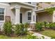 Inviting front porch with stone accents, decorative plants, and clear house number display at 10684 Words Dr, Winter Garden, FL 34787