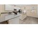 Modern kitchen features white cabinets, gray countertops, stainless steel appliances, and a kitchen island at 10684 Words Dr, Winter Garden, FL 34787
