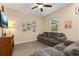 Cozy living room featuring wood-look floors, comfortable seating, and soft, neutral wall color at 10684 Words Dr, Winter Garden, FL 34787