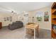 Spacious living room features tile floors, a ceiling fan, neutral paint, and a comfortable gray sofa at 10684 Words Dr, Winter Garden, FL 34787