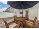 Paved outdoor patio featuring an umbrella-covered wooden table and chairs at 10684 Words Dr, Winter Garden, FL 34787