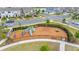 Community playground with modern equipment, safety fencing, and ample space for recreational activities at 10684 Words Dr, Winter Garden, FL 34787