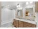 Bathroom featuring a double vanity, framed mirrors, tub, and shower at 1210 Baypoint Ct, Longwood, FL 32750