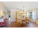 Elegant dining room with a chandelier, hardwood floors, and plenty of natural light at 1210 Baypoint Ct, Longwood, FL 32750