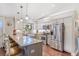 Bright kitchen featuring granite countertops, stainless steel appliances, and a breakfast bar at 1210 Baypoint Ct, Longwood, FL 32750