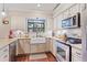 Well-lit kitchen with subway tile backsplash, stainless steel appliances, and a farmhouse sink at 1210 Baypoint Ct, Longwood, FL 32750