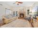 Cozy living room with a brick fireplace, comfortable seating, and lots of natural light at 1210 Baypoint Ct, Longwood, FL 32750