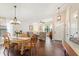 Inviting dining and living area with wood floors, modern lighting, and an open layout at 1210 Baypoint Ct, Longwood, FL 32750
