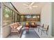 Enclosed porch with wicker furniture, ceiling fan, and a view of the yard at 1210 Baypoint Ct, Longwood, FL 32750