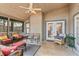 Enclosed porch featuring wicker furniture, ceiling fan, and neutral tones at 1210 Baypoint Ct, Longwood, FL 32750