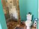 Bathroom with sleek glass enclosed shower and toilet with lovely plant accent at 12238 Still Meadow Dr, Clermont, FL 34711