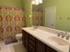 Bathroom featuring double sink vanity, with large mirror and colorful shower curtain at 12238 Still Meadow Dr, Clermont, FL 34711