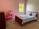 Bedroom with pink walls and a view to the exterior at 12238 Still Meadow Dr, Clermont, FL 34711