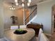 Open-concept dining room and music room with stairs to the second floor at 12238 Still Meadow Dr, Clermont, FL 34711