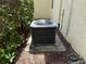 Home exterior with AC unit on a concrete pad and lush green shrubbery at 12238 Still Meadow Dr, Clermont, FL 34711