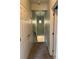 Inviting hallway with carpeted floors and decorative lighting leading to the stairs at 12238 Still Meadow Dr, Clermont, FL 34711