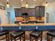 Modern kitchen featuring granite countertops, stone backsplash, dark gray cabinets, and pendant lighting at 12238 Still Meadow Dr, Clermont, FL 34711