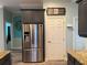Modern kitchen featuring a stainless steel refrigerator with filtered water system at 12238 Still Meadow Dr, Clermont, FL 34711