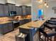 Well-equipped kitchen with granite countertops, stainless steel appliances, and stylish gray cabinetry at 12238 Still Meadow Dr, Clermont, FL 34711