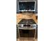 Close up on the kitchen range with stainless steel appliances, granite countertops, and tile backsplash at 12238 Still Meadow Dr, Clermont, FL 34711