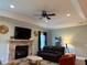 Living room with fireplace, TV, neutral tones, and lots of comfy seating at 12238 Still Meadow Dr, Clermont, FL 34711