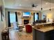 Cozy living room featuring an electric fireplace and stone hearth at 12238 Still Meadow Dr, Clermont, FL 34711