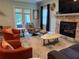 Living room showcasing cozy seating, a fireplace, and modern decor at 12238 Still Meadow Dr, Clermont, FL 34711