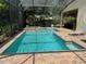 Wide view of screened-in pool featuring an in-ground spa and lounge chairs at 12238 Still Meadow Dr, Clermont, FL 34711