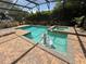 Sparkling in-ground pool and spa with brick paver deck and screened enclosure at 12238 Still Meadow Dr, Clermont, FL 34711