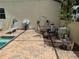 The backyard has a pool with a patio area, potted plants, and lounge chairs at 12238 Still Meadow Dr, Clermont, FL 34711