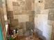 Close-up of the walk-in shower featuring multi-tone tile and sleek glass door at 12238 Still Meadow Dr, Clermont, FL 34711