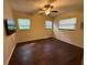 Cozy bedroom with wood floors, natural light, and modern ceiling fan, perfect for relaxation at 1528 Baltimore Dr, Orlando, FL 32810