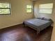 Cozy bedroom with hardwood floors, light walls and two windows, perfect for creating a relaxing retreat at 1528 Baltimore Dr, Orlando, FL 32810