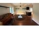 Bright dining area with wood floors, adjacent to kitchen bar, and an vintage piano at 1528 Baltimore Dr, Orlando, FL 32810