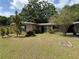 Charming single-story home featuring a well-maintained lawn and mature trees, perfect for curb appeal at 1528 Baltimore Dr, Orlando, FL 32810